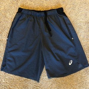 Navy blue ASICS running shorts with zipper pockets